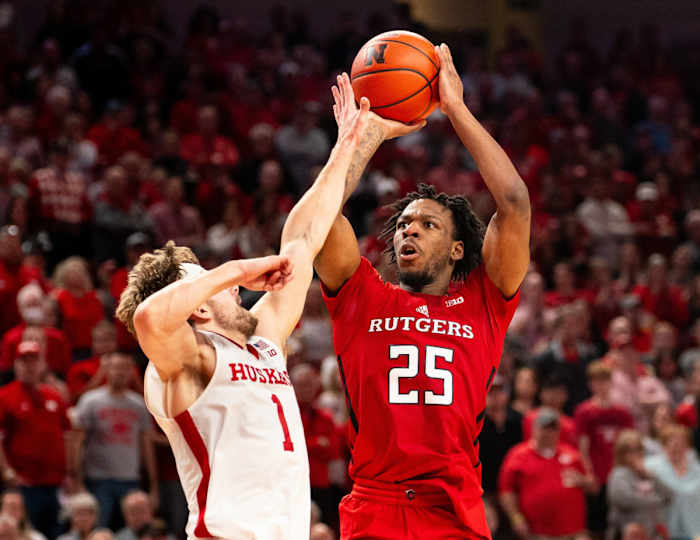 Mar 3, 2024; Lincoln, Nebraska, USA; Rutgers Scarlet Knights guard Jeremiah Williams (25) shoots a 3-point shot against Nebraska Cornhuskers guard Sam Hoiberg (1) during the second half at Pinnacle Bank Arena.